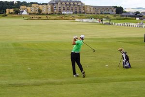 golfer swinging in scotland golf course