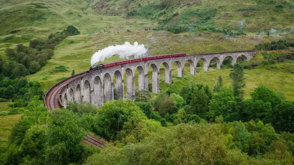 Steam train crossing the Glenfinnan Viaduct in Scotland